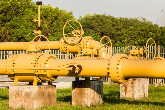 Pipeline yellow steel structure with mechanical valves outdoors for fuel liquids supply line..