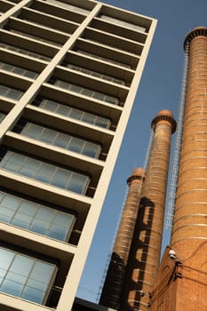 View from below of three red brick chimneys forming part of an old industrial complex in the popular district of Poble Sec, Barcelona, Catalonia, Spain