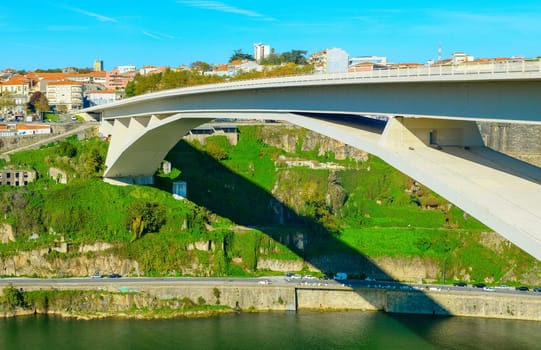 Panorama of Porto downtown with Arrabida Bridge by Douro river in bright sunny day, Portugal