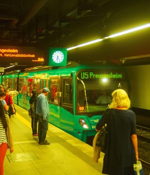 FRANKFURT AM MAIN, GERMANY - AUGUST 31, 2018: Train arriving to crowded subway platform, Frankfurt, Germany