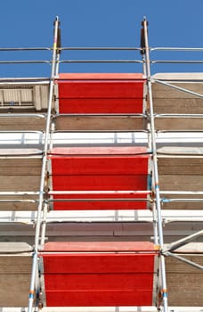 Construction site, scaffolding, red boards