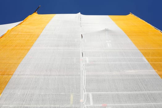 Orange-white tarpaulin, gable, scaffolding, construction site, house facade, old building, Germany, Europe