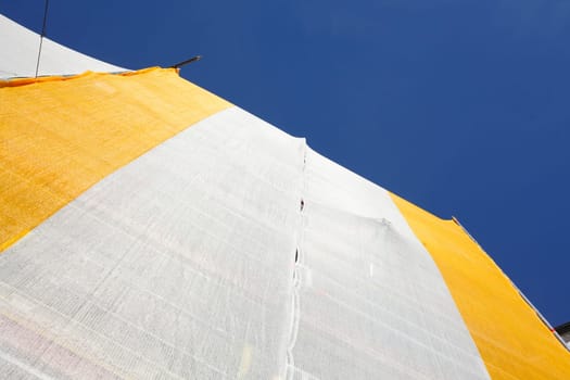 Orange-white tarpaulin, gable, scaffolding, construction site, house facade, old building, Germany, Europe