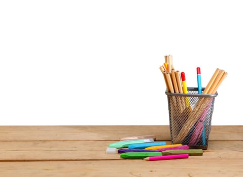 Pencils in basket container and colorful crayons on wooden table isolated over white background. Back to School concept