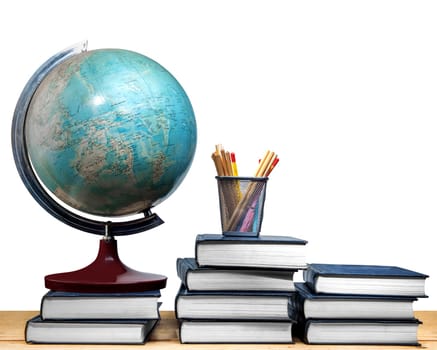 Pile of books and globe with pencils in basket container on wooden table isolated over white background. Back to School concept