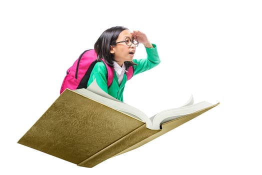 Asian cute girl with glasses and backpack sitting on book isolated over white background. Back to School concept