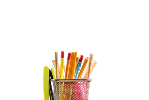 Pencils in basket container with green stapler isolated over white background. Back to School concept