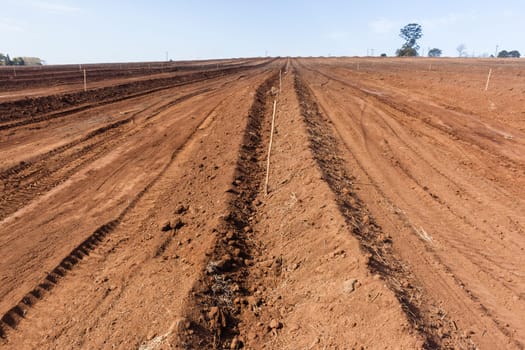 Farm field closeup tractor plowed earth soil detail agriculture background