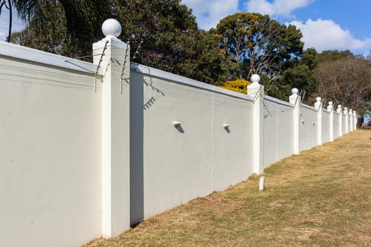 Boundary Wall high closeup with Electrified Fence for security in countryside