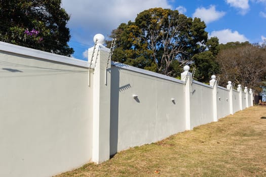 Boundary Wall high closeup with Electrified Fence for security in countryside