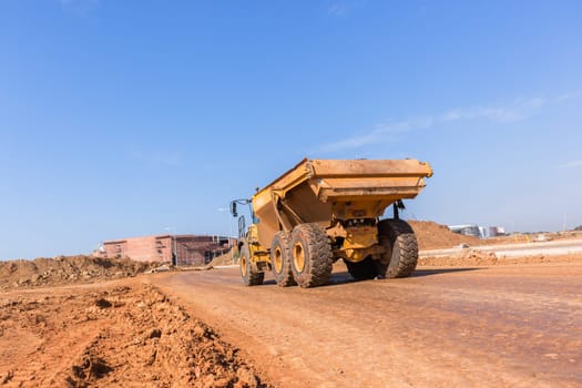 Earthworks large heavy industrial truck moving on industrial building project site