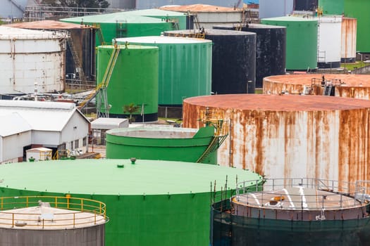 Storage steel industrial liquids oils tanks depot for fuels chemicals overlooking structures.