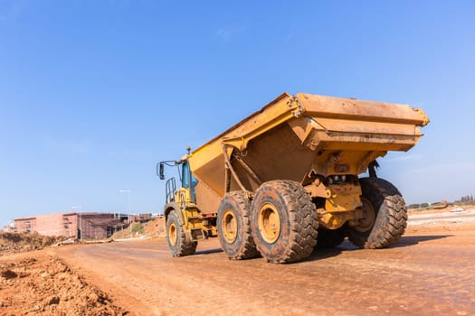 Earthworks large heavy industrial truck moving on industrial building project site