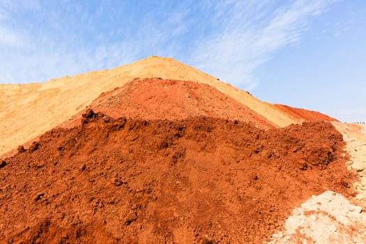 Earth sand mounds embankments of soil colors on industrial project construction landscape