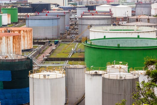 Storage steel industrial liquids oils tanks depot for fuels chemicals overlooking structures.