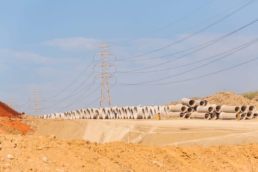 Construction new road infrastructure project development build concrete pipes earthworks industrial machines  countryside.