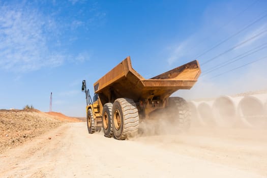 Earthworks large heavy industrial truck moving on industrial building project site