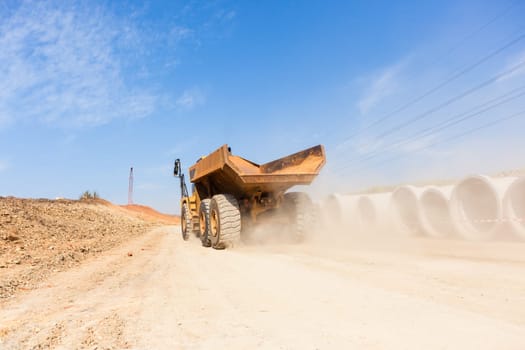 Earthworks large heavy industrial truck moving on industrial building project site