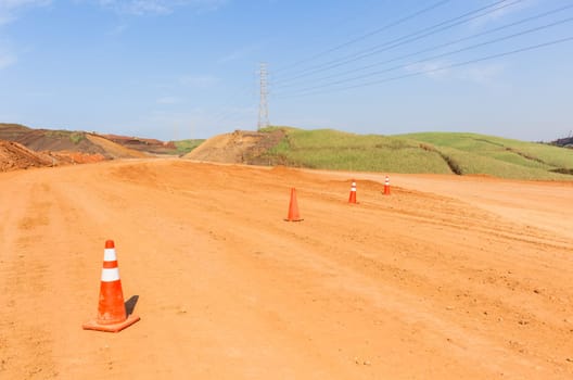 Construction new road infrastructure project development build concrete pipes earthworks industrial machines  countryside.