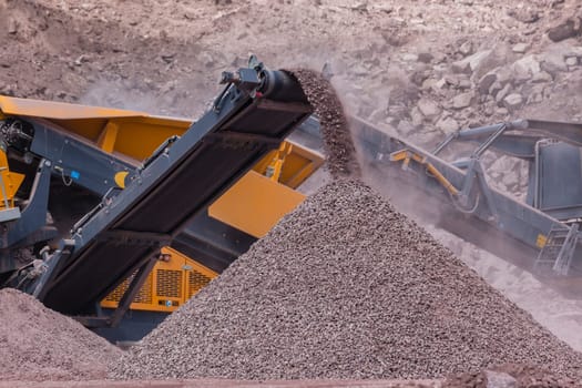 Construction mobile industrial quarry stone crushing machines producing mix grades for concrete cement on building site.