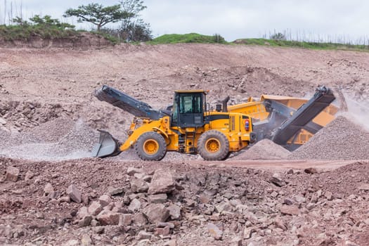 Construction mobile industrial quarry stone crushing machines producing mix grades for concrete cement on building site.