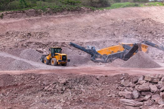 Construction mobile industrial quarry stone crushing machines producing mix grades for concrete cement on building site.