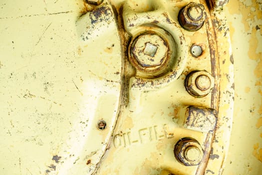 Close-up image of old machinery part with oil fill port