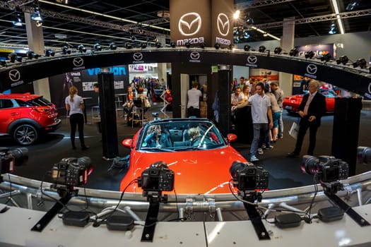 COLOGNE, GERMANY - SEPTEMBER 22, 2016: Photokina Exhibition interior. The Photokina is the world's largest trade fair for the photographic and imaging industries. Mazda stand in the Photokina Exhibition.