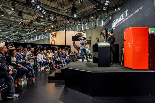 COLOGNE, GERMANY - SEPTEMBER 22, 2016: Photokina Exhibition interior. The Photokina is the world's largest trade fair for the photographic and imaging industries. Adobe stand in the Photokina Exhibition.