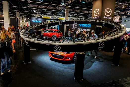 COLOGNE, GERMANY - SEPTEMBER 22, 2016: Photokina Exhibition interior. The Photokina is the world's largest trade fair for the photographic and imaging industries. Mazda stand in the Photokina Exhibition.