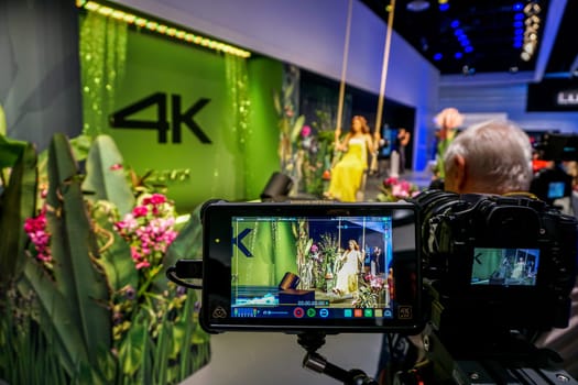 COLOGNE, GERMANY - SEPTEMBER 21, 2016: Photokina Exhibition interior. The Photokina is the world's largest trade fair for the photographic and imaging industries. 4k video advertising in the Photokina Exhibition.