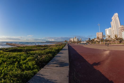 Beach Ocean Promenade Durban South-Africa Photo of beach front promenade ocean waves surfers piers cycling people lifestyle landscape.