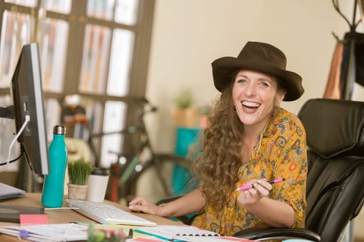 Stylish professional woman laughing in her office