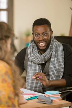 African American laughing man in an office with client or coleague
