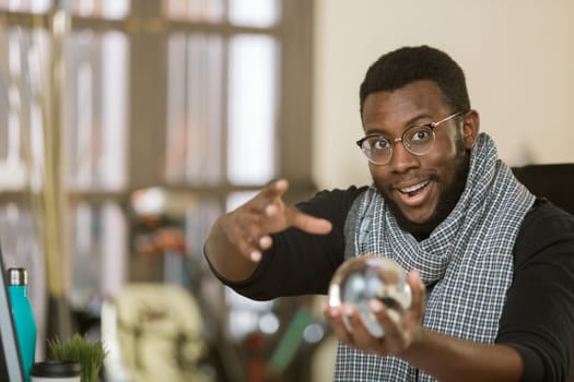 Confident creative professional man with a crystal ball