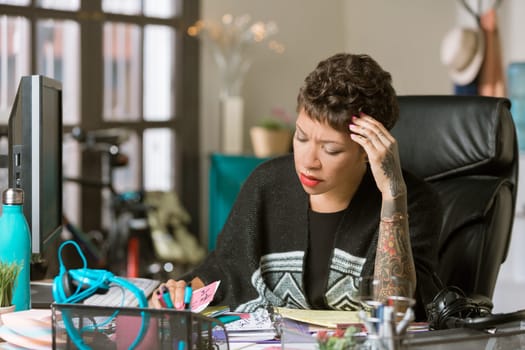 Worried or overworked professional woman in her office