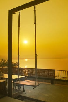 Wood swing of beautiful sunset on Khuean Srinagarindra National Park at Kanchanaburi , Thailand and sky for travel in holiday relax time