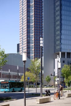 Frankfurt, Germany - April 18, 2019: Bus traffic and infrastructure in front of the Festhalle Messe Frankfurt and the Kastor skyscraper on April 18, 2019 in Frankfurt. ..