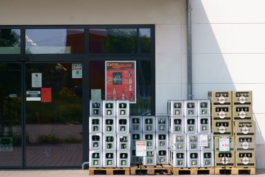 Mainz, Germany - May 24, 2019: Beverage boxes of various mineral water producers as well as beer brands in front of the entrance of the Profi beverage shop on May 24, 2019 in Mainz..