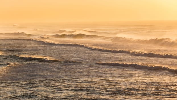 Beach ocean waves offshore winds spray morning overlooking golden color landscape