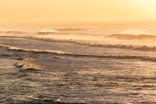 Beach ocean waves offshore winds spray morning overlooking golden color landscape