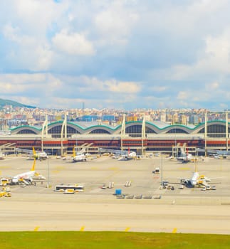 ISTANBUL, TURKEY - MAY 23, 2017: Planes at airfield of Istanbul International Airport, cityscape in backgrund, Turkey