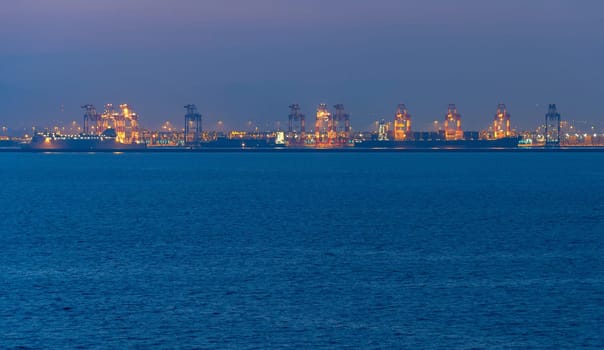 Landscape with a sea and industrial port at twilight. Barcelona, Spain