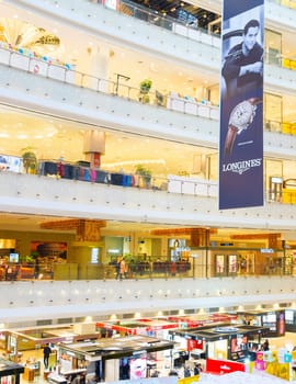 SHANGHAI, CHINA - Dec 28, 2016: People at the New World shopping mall in Shanghai. Famous for it’s world largest spiral escalator