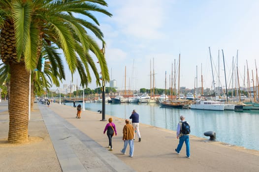 BARCELONA, SPAIN - NOVEMBER 03, 2016: People walking at Barcelona Port Vell. Port Vell is the oldest port in Barcelona. Famous tourist destination