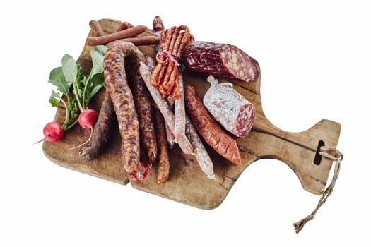 Wooden board with assortment of spicy German sausages or wurst served with fresh radishes for a tasty regional snack or lunch isolated on white high angle