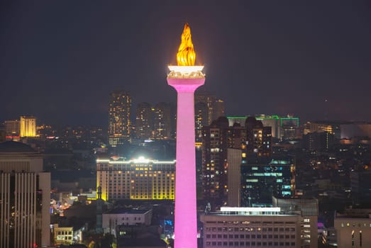 Jakarta city skyline with iconic symbol likes National Monument (Monas) at night. Jakarta, Indonesia