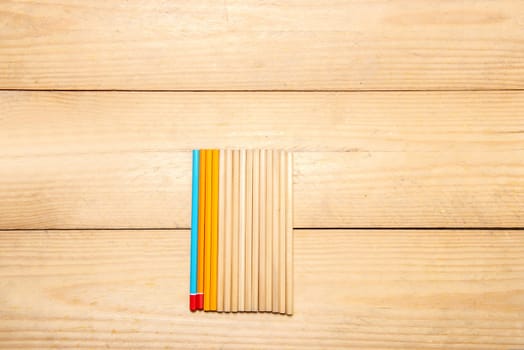 Row of stationery of pencils on the wooden table. Back to School concept