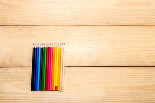 Row of colorful stationery of pencils for drawing on the wooden table. Back to School concept