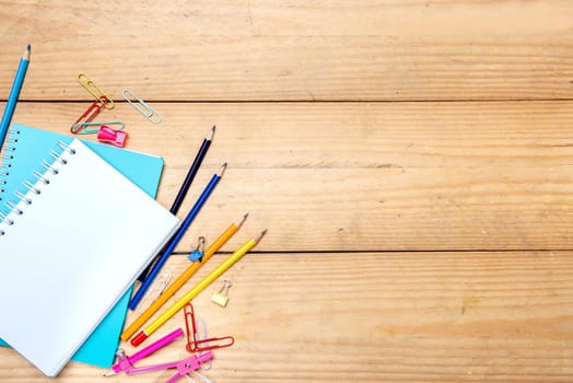 Notebooks with school supplies and stationery on the wooden table. Back to School concept